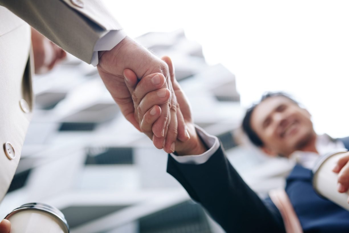 Business partners shaking hands Close-up image of business partners shaking hands after having successful meeting